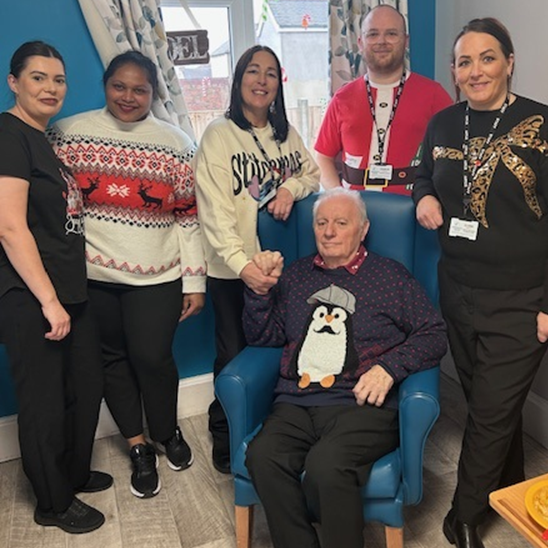 Staff and residents in Christmas jumpers